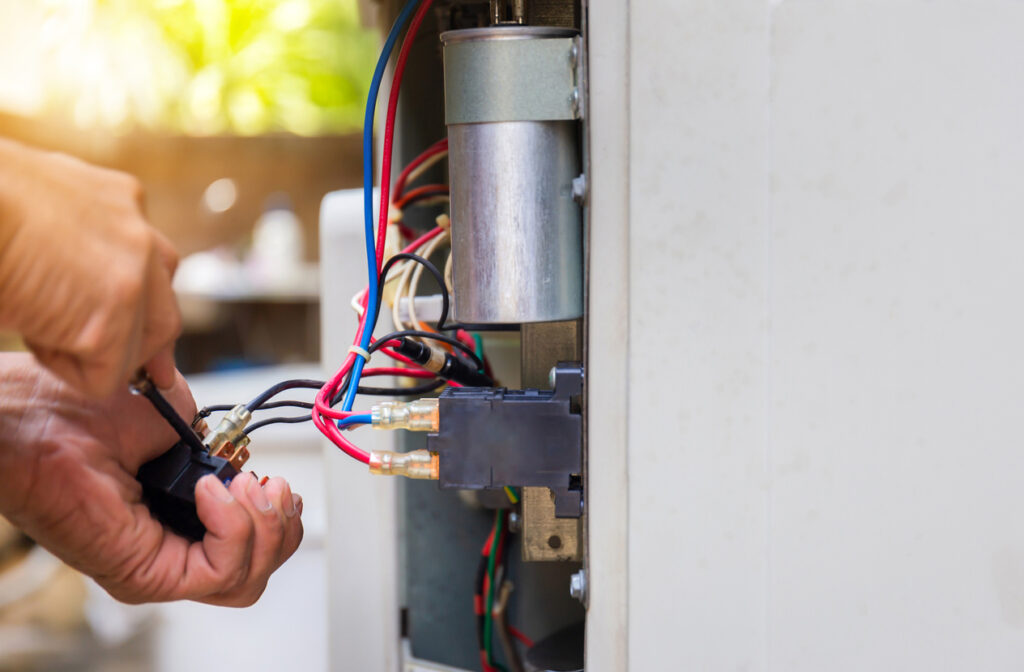 Air Conditioning Repair, repairman fixing air conditioning system, changing magnetic contactor