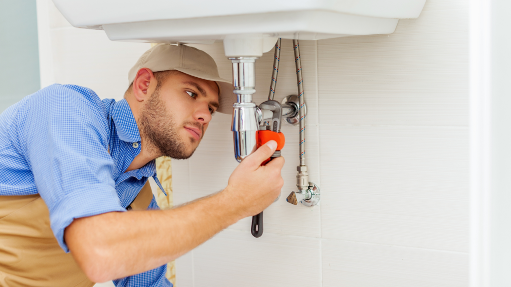 Plumber fixing sink